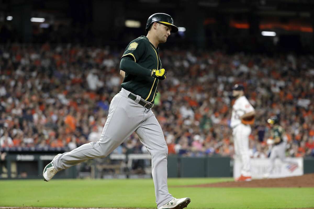 Oakland Athletics' Chad Pinder runs the bases after hitting a three-run home run against the Houston Astros during the fourth inning of a baseball game Wednesday, July 11, 2018, in Houston.