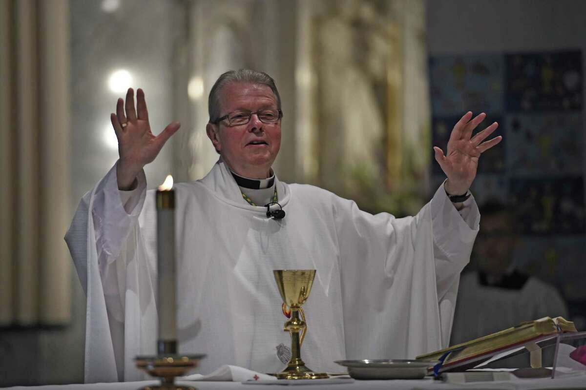 Bishop Edward Scharfenberger raises his hands in prayer during the Mass for St. Augustine's School June 3, 2016 in Troy, N.Y. (Skip Dickstein/Times Union) ORG XMIT: MER2016060314405224