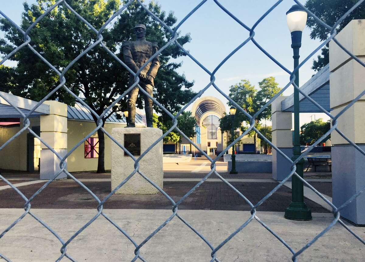 The 6-foot chain-link fence that surrounds Guadalupe Plaza was installed two years ago. Behind the fence and pictured in the backgroun, the plaza’s playground sits unused.