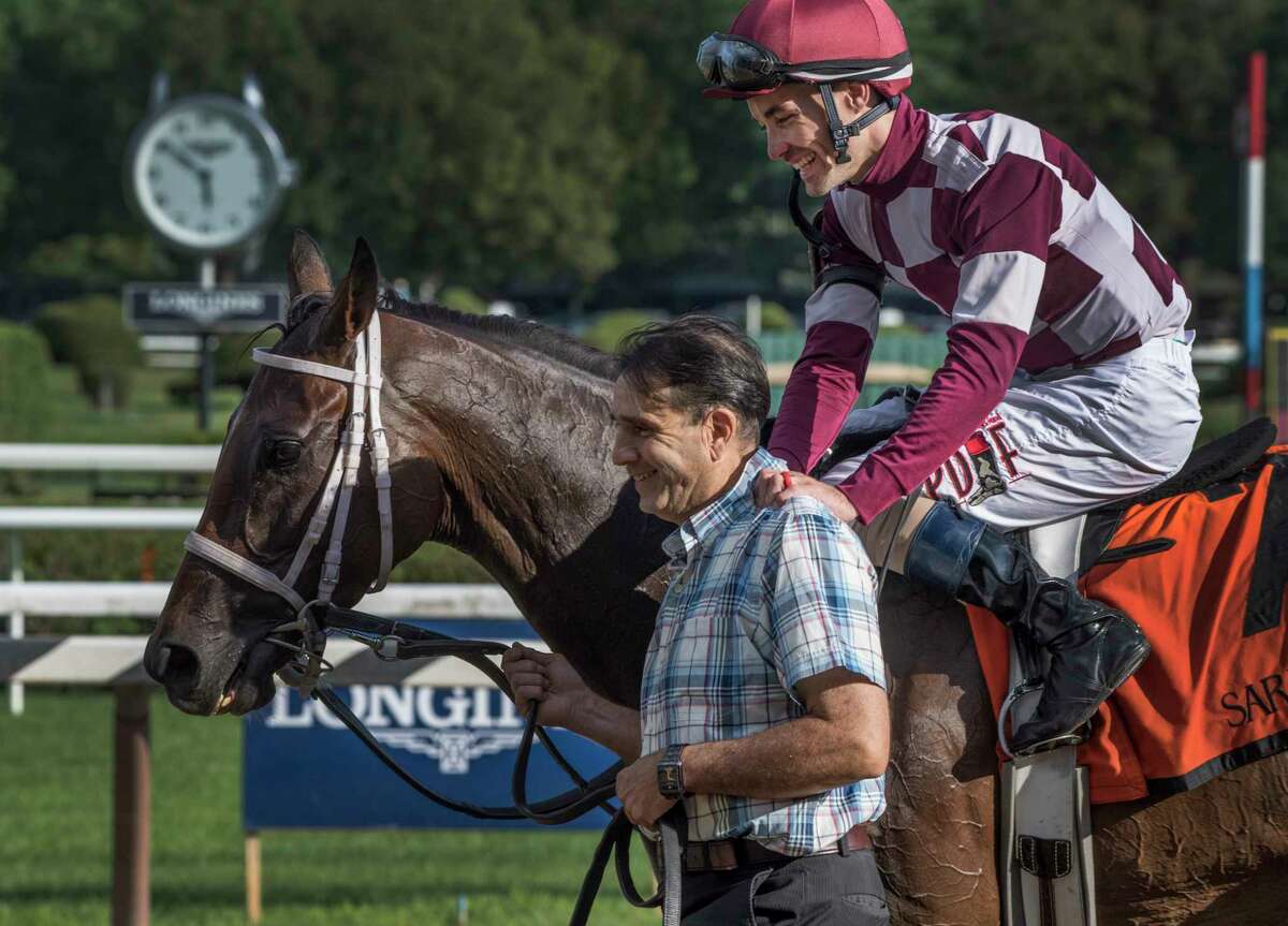 Jockey Channing Hill sits atop Farrell and hugs the person leading the horse to the winner's circle after winning the 42nd running of the Grade III Shuvee at the Saratoga Race Course Sunday July 29, 2018 in Saratoga Springs, N.Y. (Skip Dickstein/Times Union)