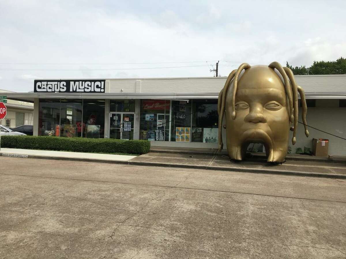 The Travis Scott head was moved to outside Cactus Music on Monday morning.