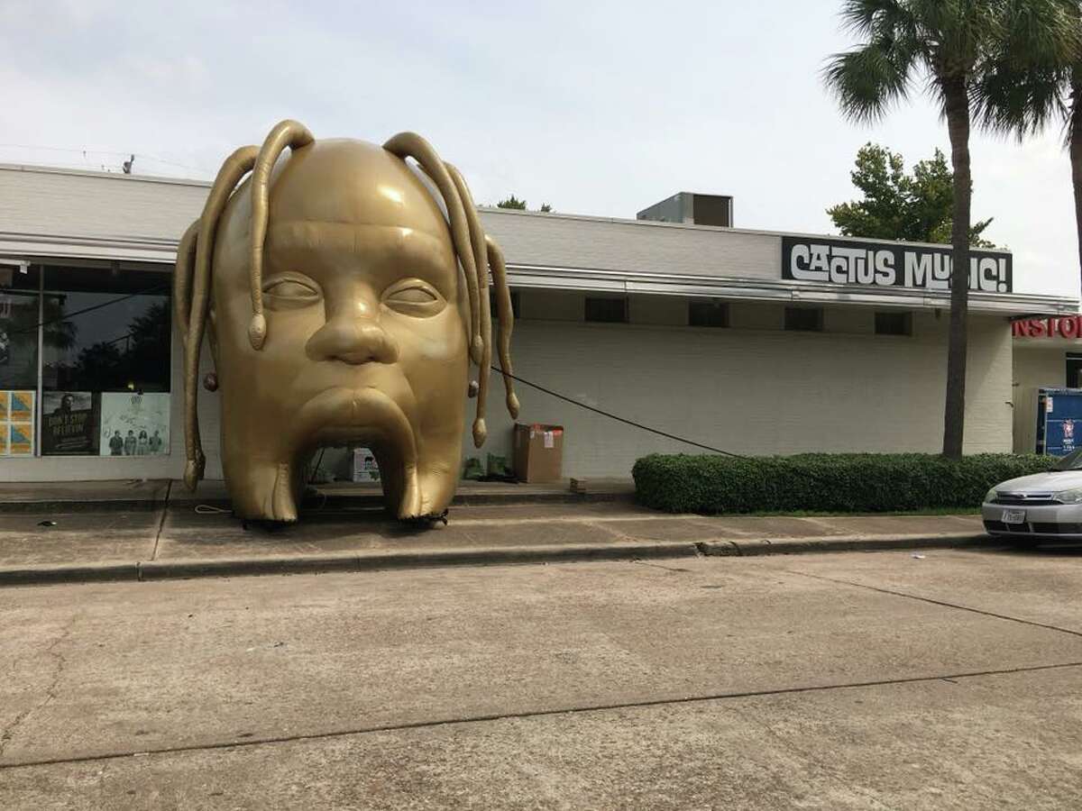 The Travis Scott head was moved to outside Cactus Music on Monday morning.
