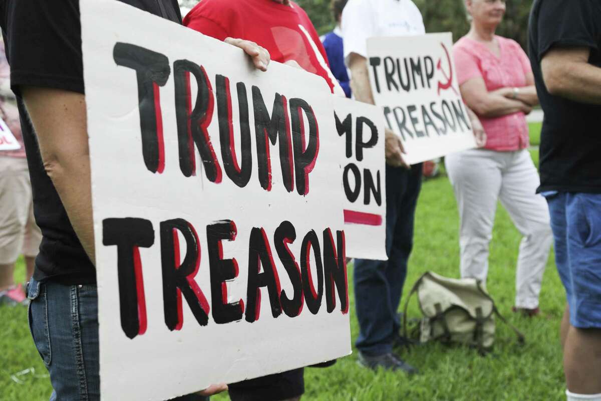 Protesters listen during a rally at Demens Landing in St. Petersburg on Wednesday, July 18, 2018. Protesters were rallying against President Trump's denial earlier this week of Russian collusion in the 2016 election. (Eve Edelheit/Tampa Bay Times via AP)