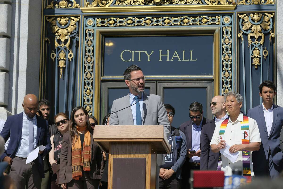 San Francisco Supervisor Ahsha Safai, an Iranian-American, speaks during a news conference by impacted community members about the Supreme Court decision on the ban of travel from several mostly Muslim countries outside City Hall Tuesday, June 26, 2018, in San Francisco. Muslim individuals and groups, as well as other religious and civil rights organizations, expressed outrage and disappointment at the high court's rejection of a challenge that claimed the policy discriminated against Muslims or exceeded the president's authority. (AP Photo/Eric Risberg)