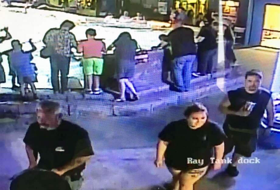   Police released a plan of a surveillance video of two men and one woman who were linked to the robbery of a gray horn shark at the Aquarium of San Antonio . One of the men was seen on a surveillance video, reaching the tank and removing the shark from the show. Photo: Leon Valley Police Department 