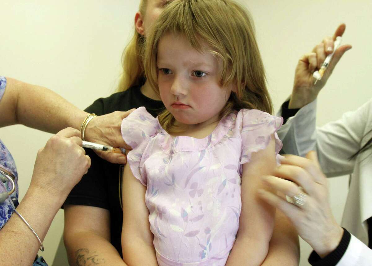 In this April 2012 AP file photo, a 4-year-old gets vaccinations at the doctor's office.