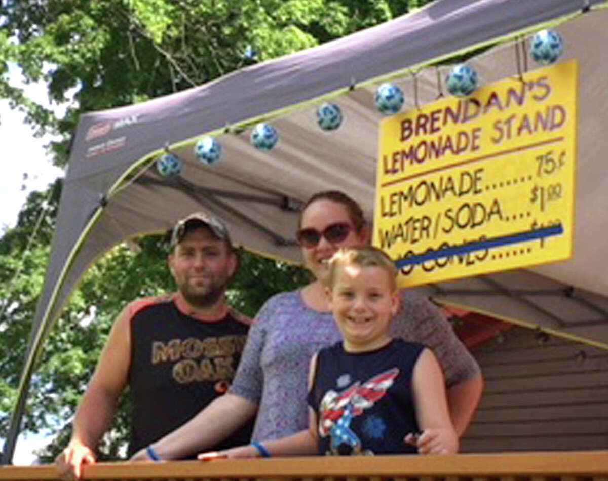 From left, Sean, Jodi and Brendan Mulvaney stand on the deck of their home where 7-year-old Brendan's lemonade stand was shut down by a woman who claims she was the state Department of Health on Friday, July 27, in Ballston Spa.