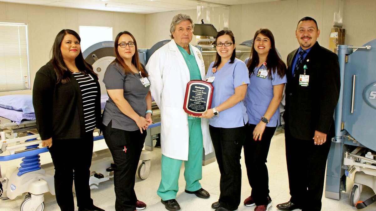 Wound Healing Center Medical Director Dr. Manuel Gonzalez and staff alongside the WHC’s hyperbaric oxygen therapy chambers.