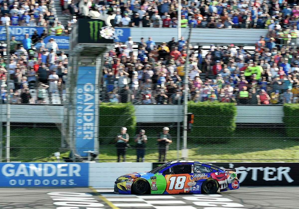 Kyle Busch crosses the finish line to win a NASCAR Cup Series auto race, Sunday, July 29, 2018, in Long Pond, Pa. (AP Photo/Derik Hamilton)