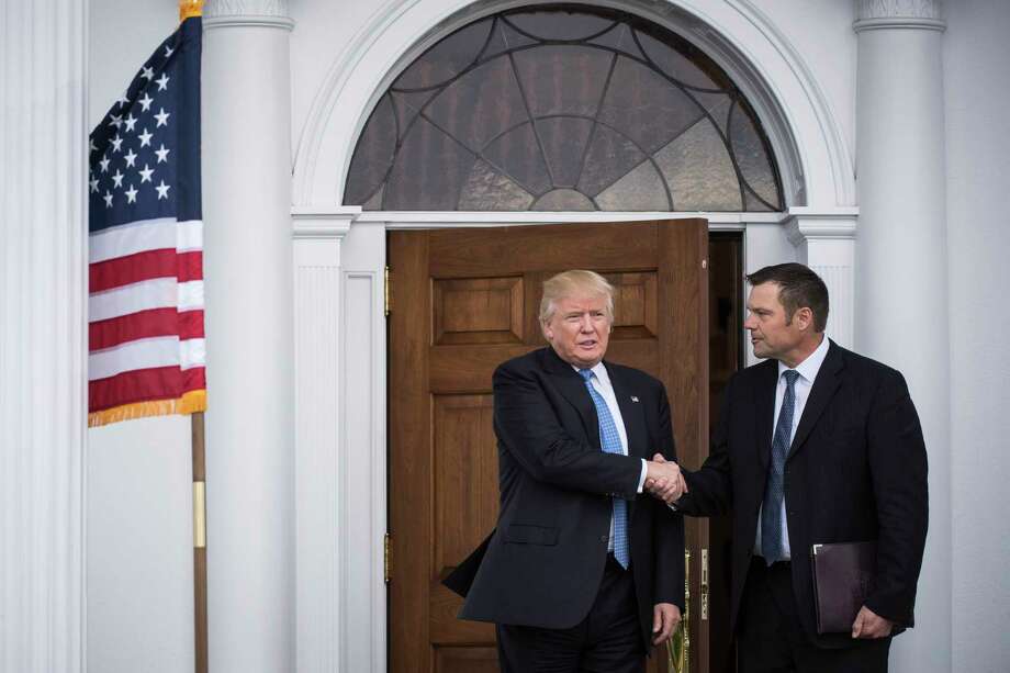 Donald Trump, then president-elect, greets Kansas Secretary of State Kris Kobach at the clubhouse at Trump National Golf Club Bedminster in New Jersey in November 2016. Photo: Washington Post Photo By Jabin Botsford / The Washington Post
