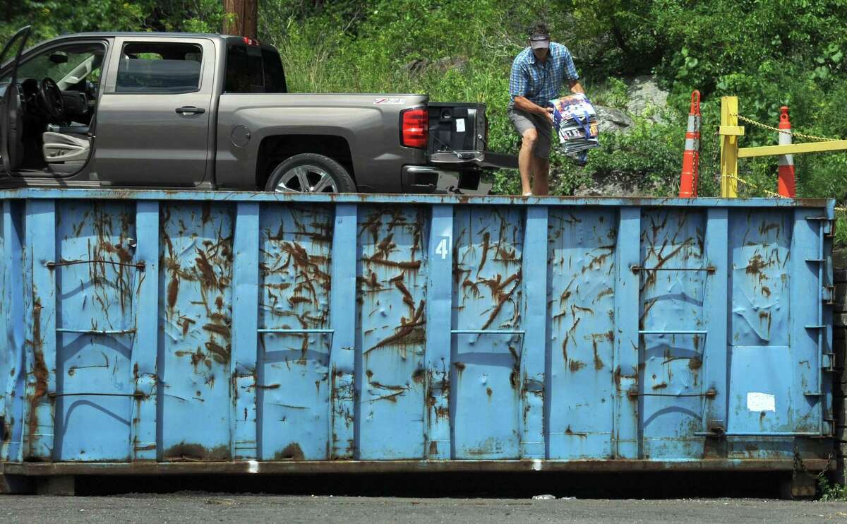Wilton resident Damian Pendergast dumps recyclable material at The Wilton Transfer Station Thursday, July 26, 2018, in Wilton, Conn. The Wilton Transfer Station could be negatively affected by a ban on contaminated recyclables in China.