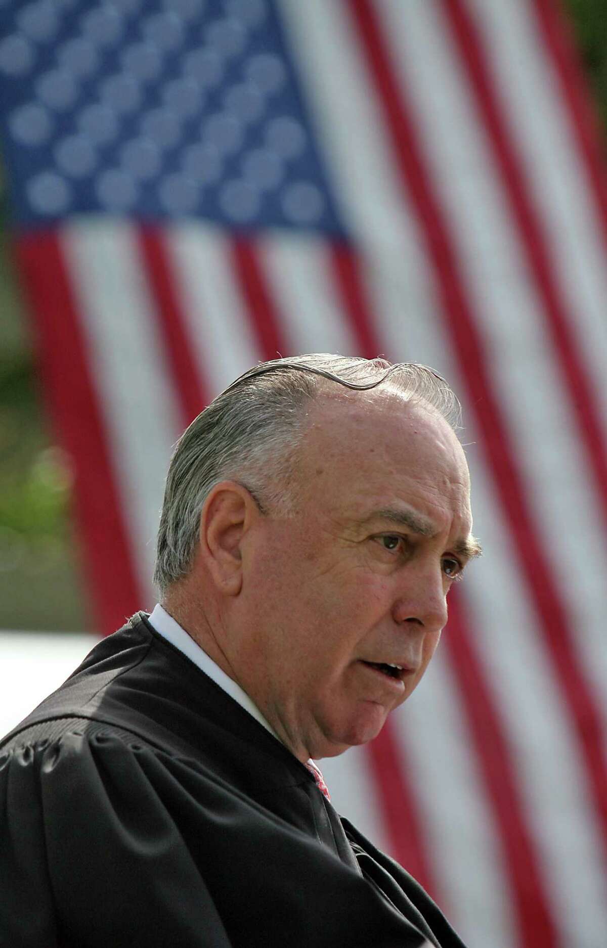 Judge T.S. Ellis III presides over a 2008 naturalization ceremony at Arlington National Cemetery in Virginia.