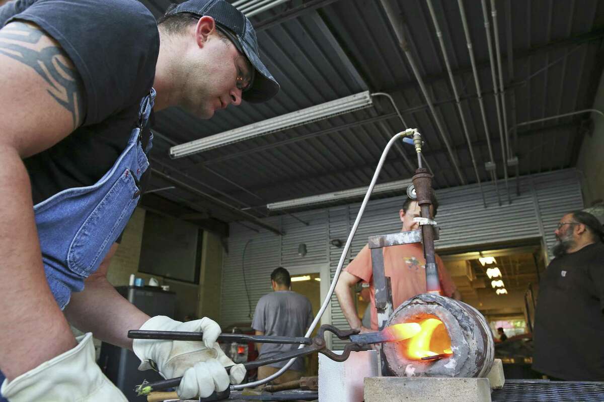 Joe Peche heats up his steel during a bladesmithing class at the Southwest School of Art. Bladesmithing is the term for those who use blacksmith techniques — heat, steel, hammer — to craft knives, swords, daggers and other cutting tools.