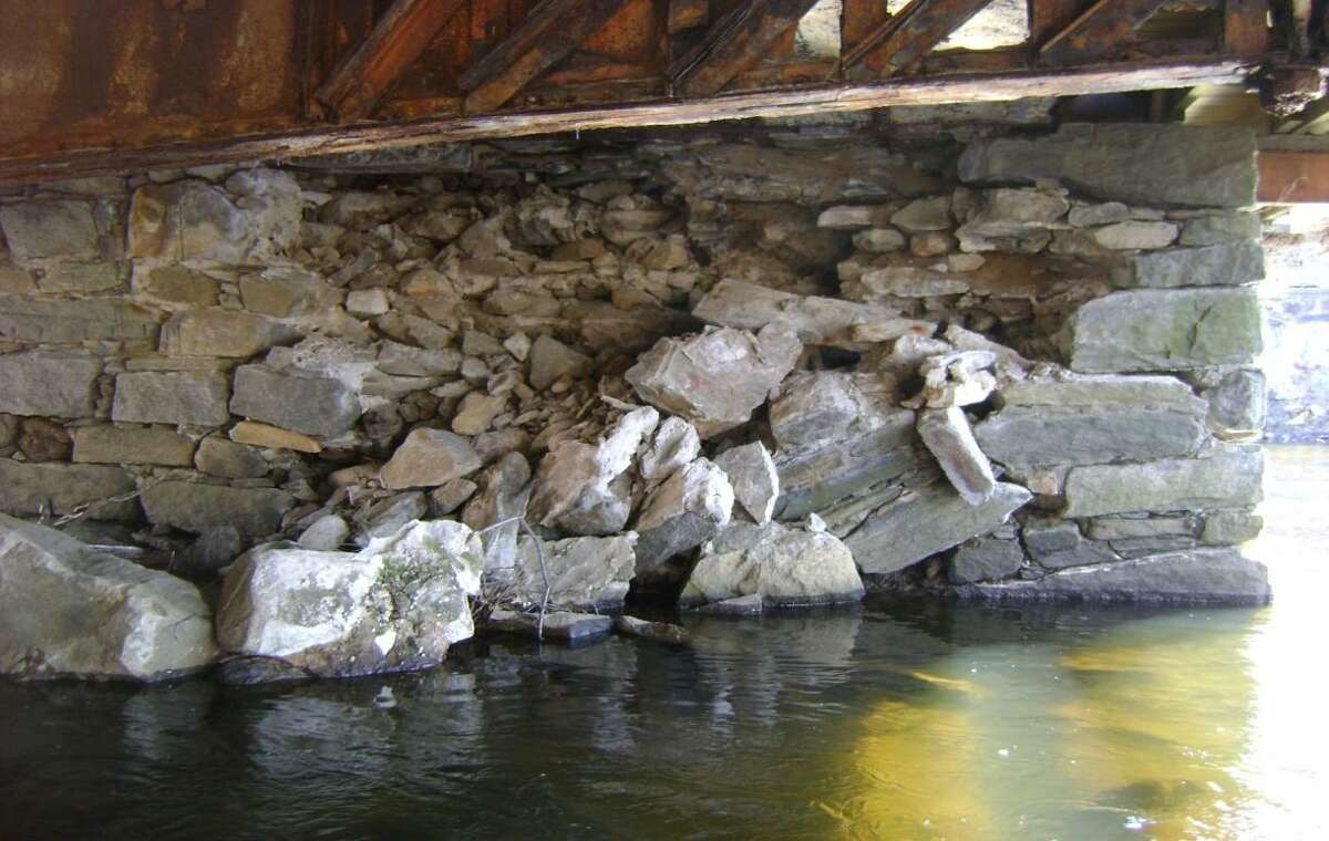 The downstream section of the West Main Street bridge is collapsing and the floor beams have corroded.