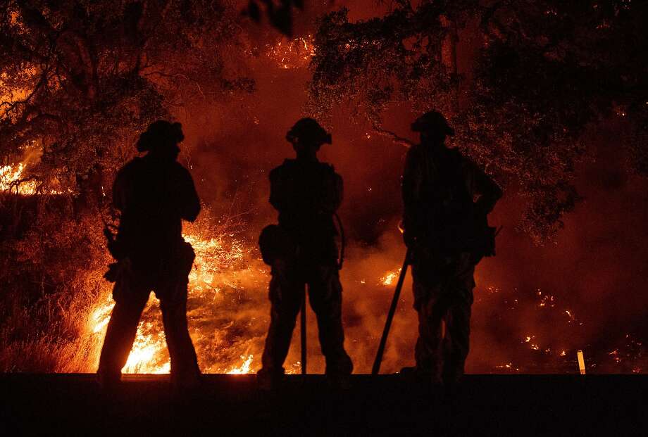 FILE -- Firefighters at the Mendocino Complex fire. A fire was moving through the Santa Cruz Mountains Sunday, burning up to 25 acres and continuing to spread. Photo: AFP Contributor#AFP