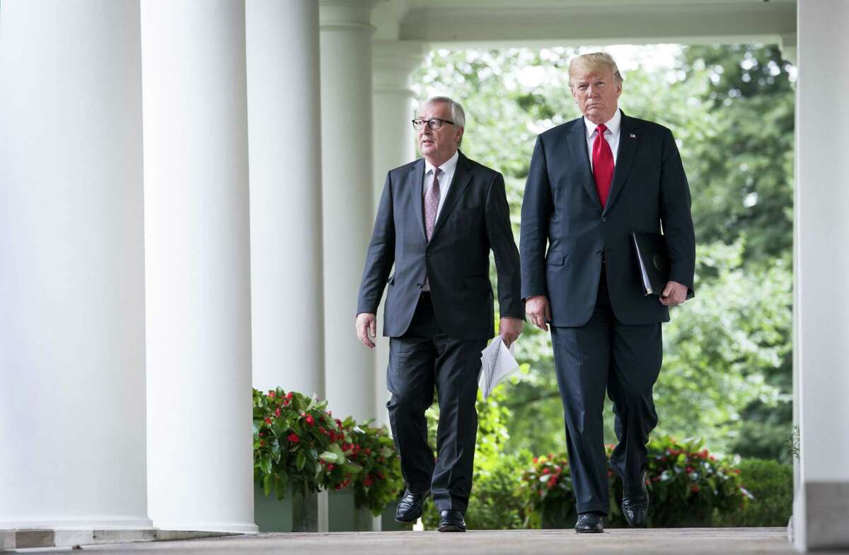 President Donald Trump walks with Jean-Claude Juncker, the European Commission president, at the White House July 25. Trump announced a truce and negotiations with the EU.
