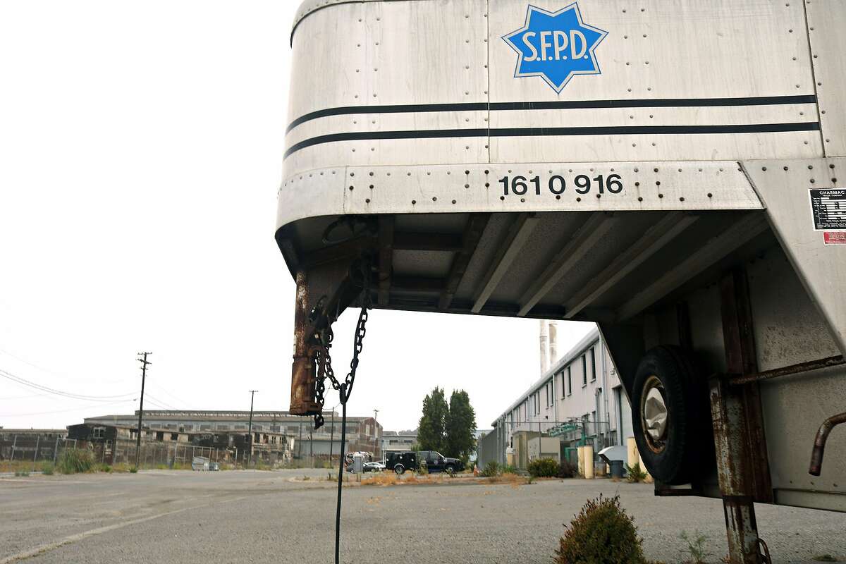 Building 606 (background right) and other structures are seen behind a SFPD trailer at the former Hunters Point Naval Shipyard on Wednesday, July 25, 2018 in San Francisco, Calif.