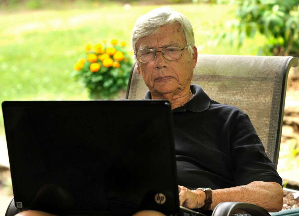 Forrest Palmer works with a laptop computer on the patio of his Southbury home on Thursday, July 8, 2010. He recently received a lifetime achievement award from the Connecuticut Council on Freedom of Information.