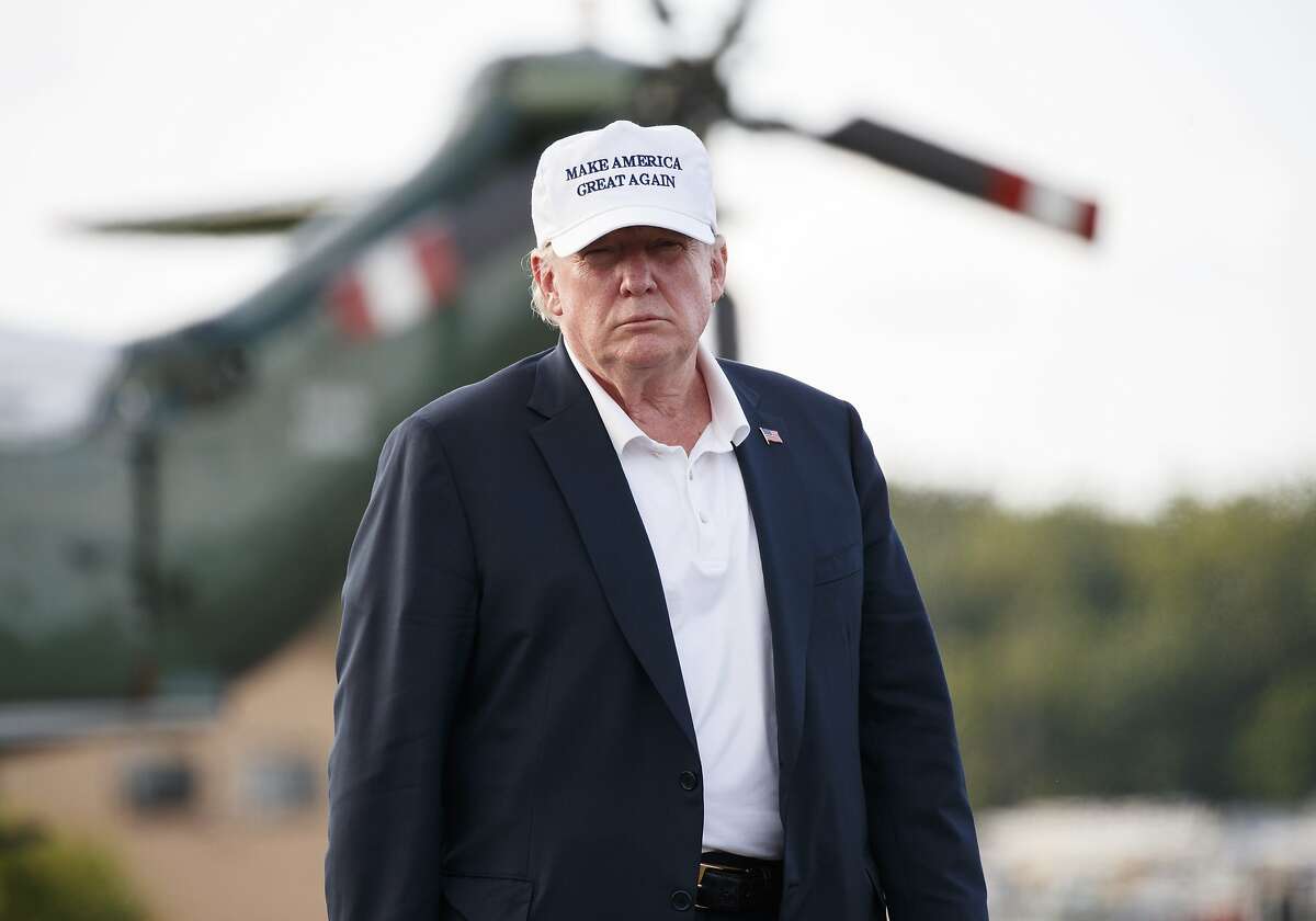 President Donald Trump looks to the media as he walks from Marine One to board Air Force One at Morristown Municipal Airport, in Morristown, N.J., Sunday, July 29, 2018, en route to Washington after visiting Trump National Golf Club in Bedminster, N.J. (AP Photo/Carolyn Kaster)