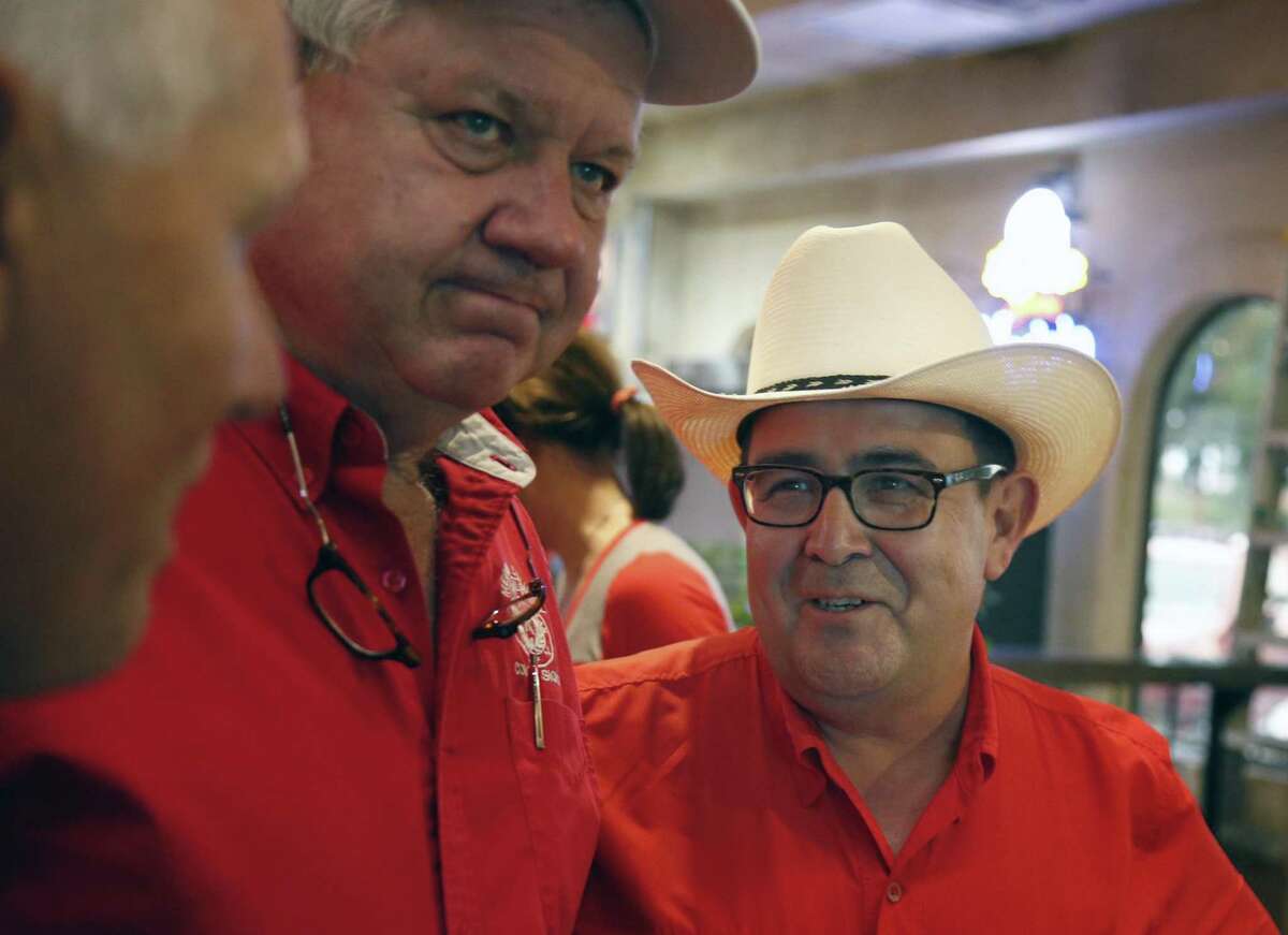 Republican Pete Flores,R, after finding out he has taken second place behind Pete Fallen. On the left is Terry Beck, Larry Sitter,middle. Republican Pete Flores, a retired Texas game warden, is holding his SD19 election night watch party at Don Pedro Mexican Restaurant, 1526 SW Military Dr. on Tuesday, July 31, 2018.