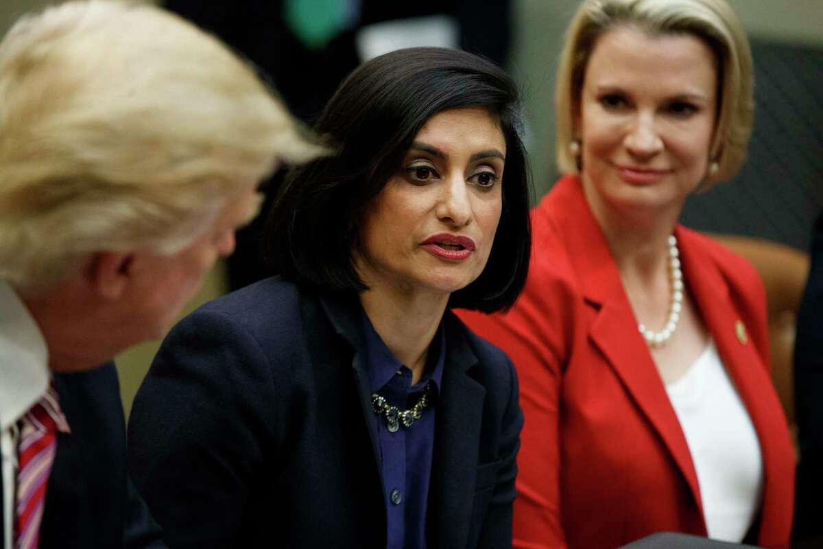 FILE - In this March 22, 2017, file photo President Donald Trump , left, and Texas State Sen. Dawn Buckingham, right, listen as Administrator of the Centers for Medicare and Medicaid Services Seema Verma speaks during a meeting on women in healthcare in the Roosevelt Room of the White House in Washington. Federal officials proposed a new fiscal accountability rule for Medicaid programs, and critics said less federal funding would come into their medical centers as a result.