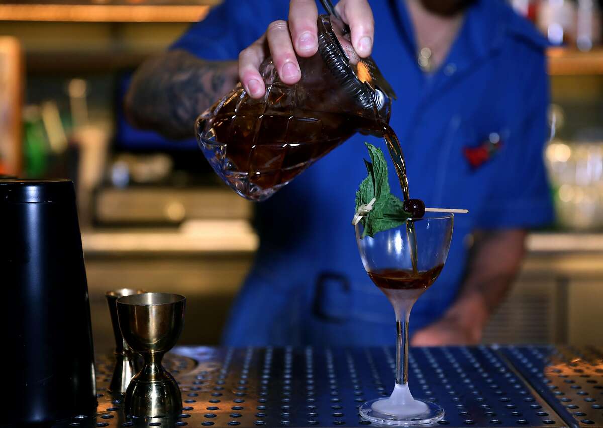 Bartender Gabriel Lowe makes a Valley of the Shadow, a cocktail at Last Rites, in San Francisco, Cali. on Tuesday, July 31, 2018. The new tiki bar is located at 718 14th St., in the Duboce/Castro neighborhood.
