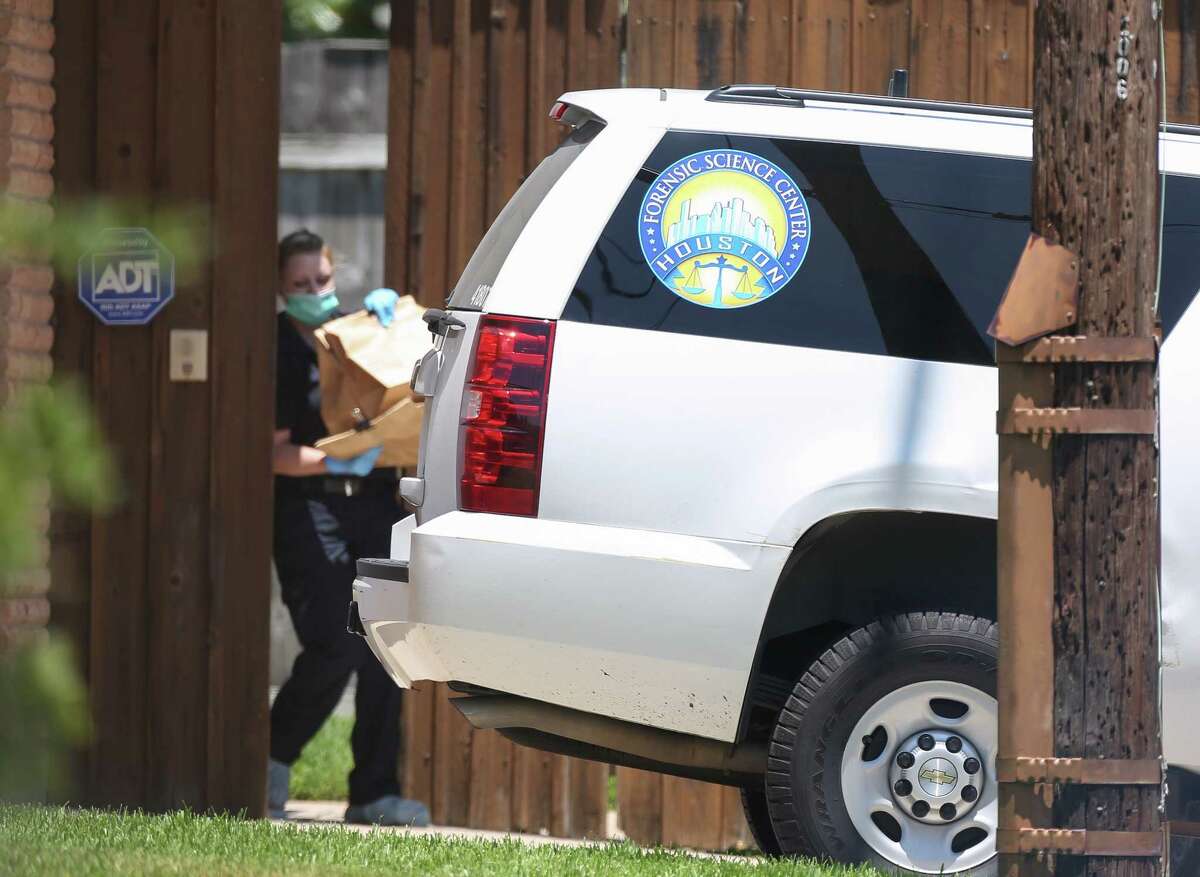 HPD investigative officials transfer collected items from a house located near the intersection of Doud Street and Stillbrooke Drive into the Houston Forensic Science Center van on Wednesday, Aug. 1, 2018, in Houston.