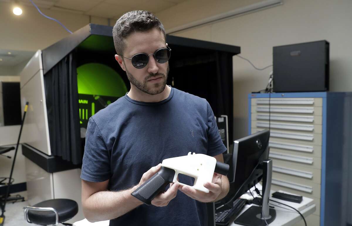 Cody Wilson, with Defense Distributed, holds a 3D-printed gun called the Liberator at his shop, Wednesday, Aug. 1, 2018, in Austin, Texas. A federal judge in Seattle issued a temporary restraining order Tuesday to stop the release of blueprints to make untraceable and undetectable 3D-printed plastic guns. (AP Photo/Eric Gay)