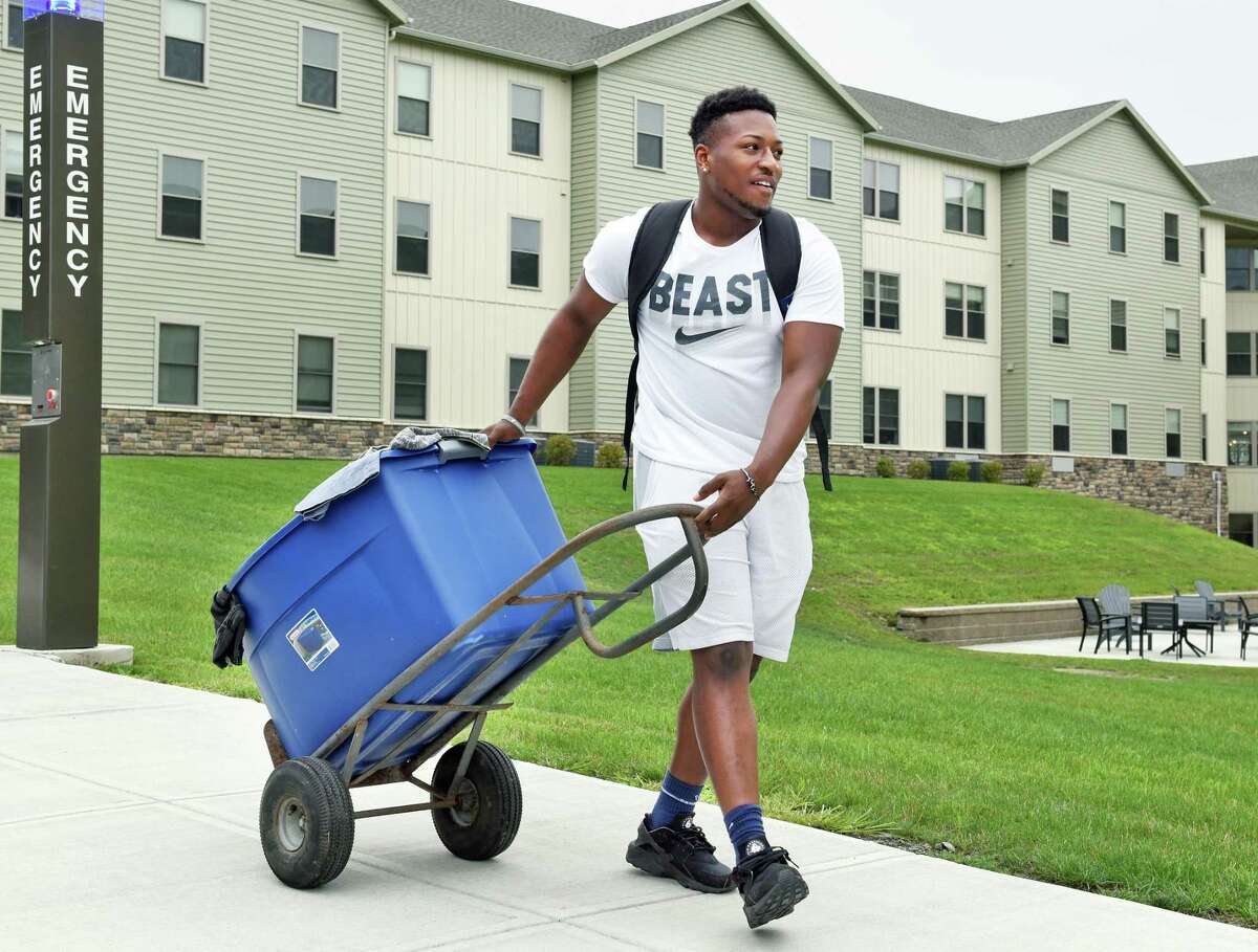 Football player Tahj Snow of Rochester wheels in his belongings during Athlete Move-in at the College Suites at Hudson Valley Wednesday August 1, 2018 in Troy, NY. (John Carl D'Annibale/Times Union)