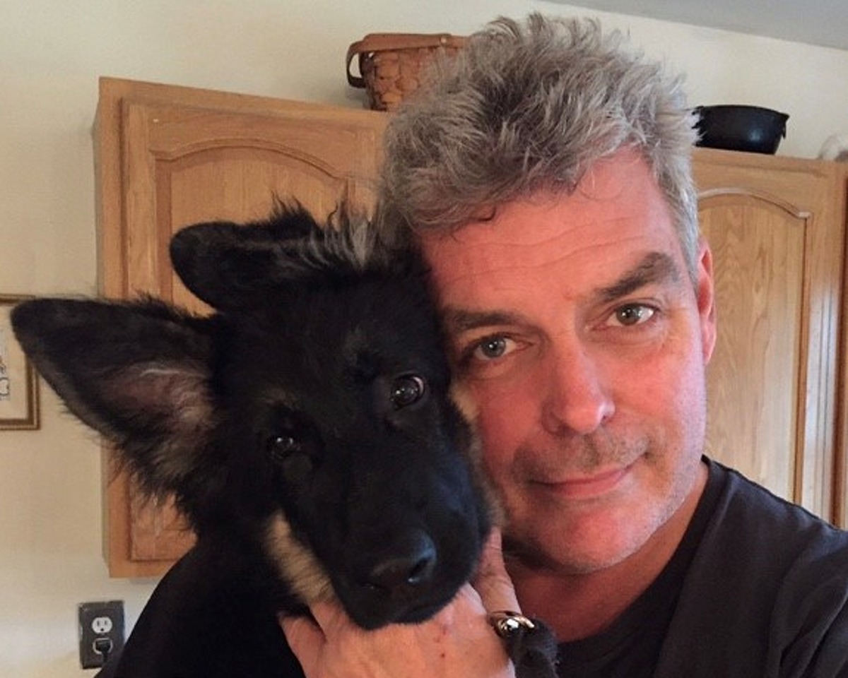 John Gray with Samuel, his German shepherd dog who died at 6 months old, inspiring Gray's book for children, "God Needed a Puppy." (Photo provided)