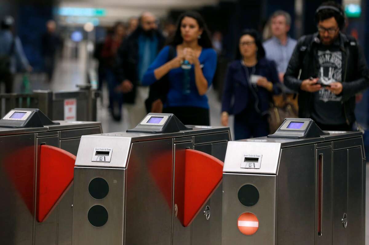 Arriving passengers approach the fare gates at the 19th Street BART station in Oakland, Calif. on Thursday, Aug. 2, 2018. BART is setting up a bus bridge between the West Oakland station and the 19th Street and Lake Merritt stations during selected weekends in August and September to perform critical track work.