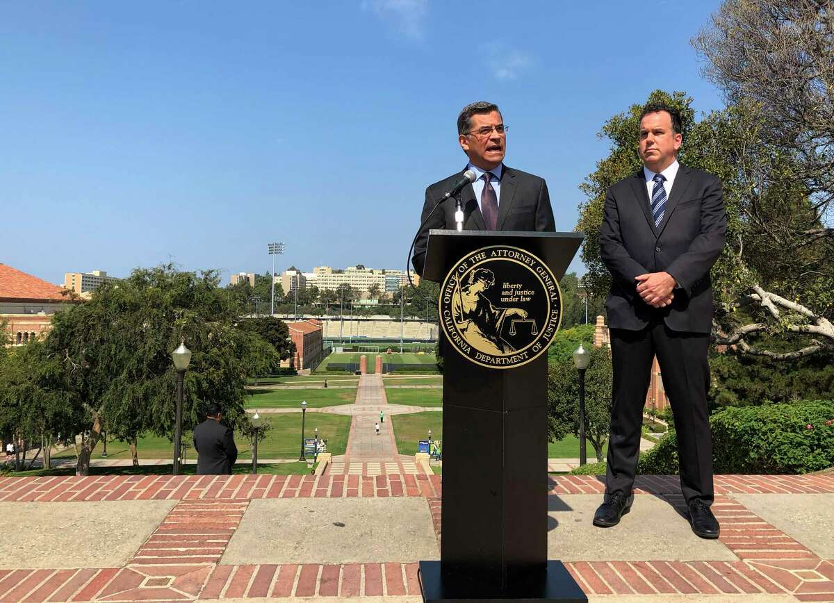 California Attorney General Xavier Becerra speaks at UCLA about his efforts to fight the Trump administration's proposal to weaken car efficiency fuel standards in Los Angeles on Thursday, Aug. 2, 2018. Deputy Attorney General David Zaft is on the right. (AP Photo/Brian Melley)