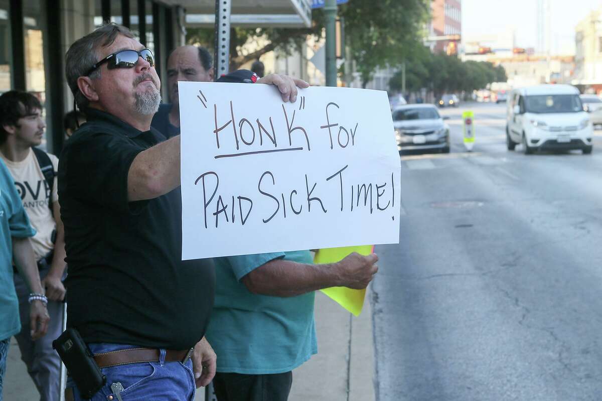 Rick Sisk holds up a “‘Honk’ for Paid Sick Time!” sign to passing cars as members of Working Texans for Paid Sick Time rally in front of City Hall, Aug. 2, 2018. A reader warns business owners to read up on the legislation effective Aug. 1 to protect their businesses.