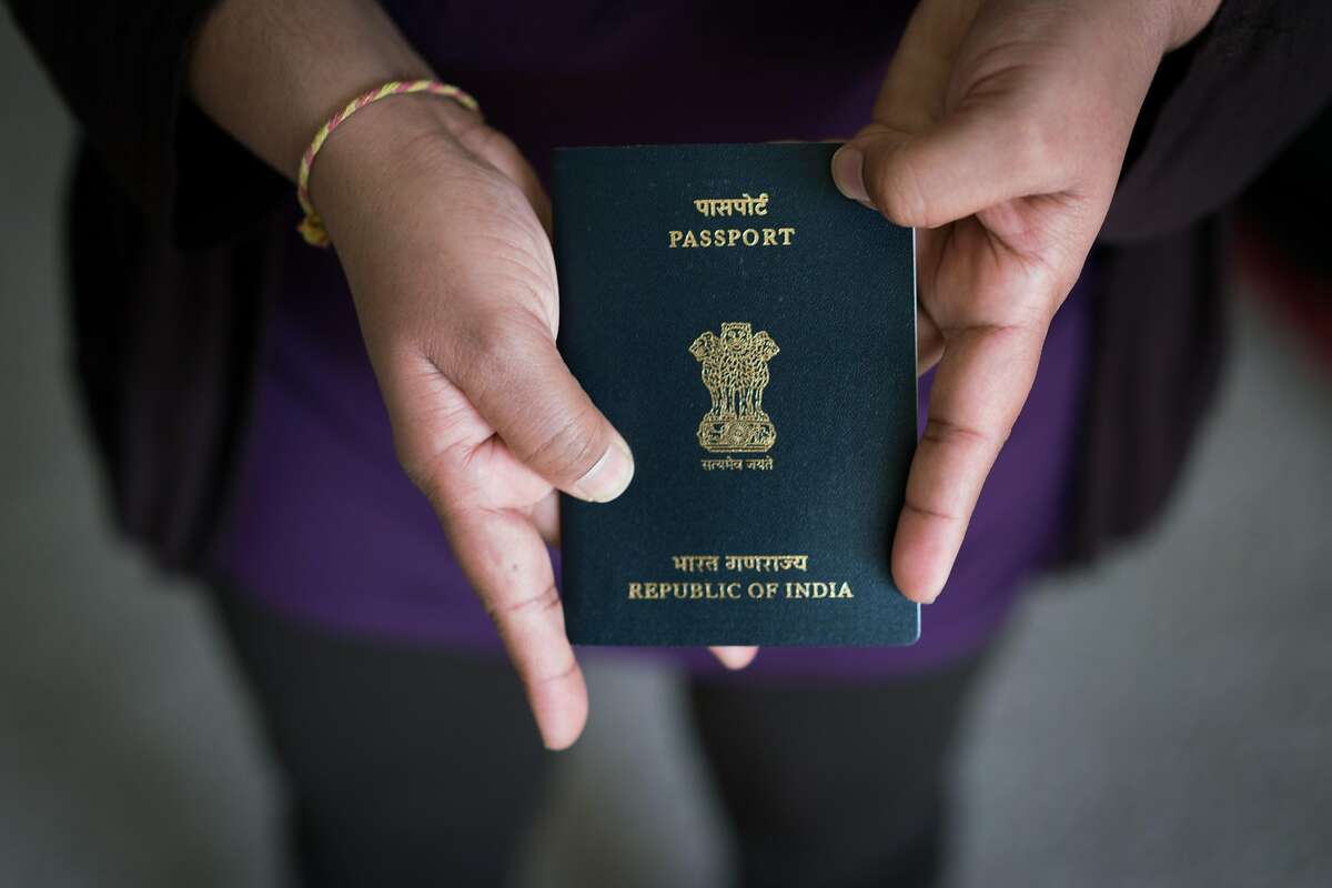 A woman with an H-4 visa� shows her passport at her home in Fremont, Calif. on Friday, June 29, 2018. The Trump administration is moving forward with a new rule to ban H-4 visa holders, who are overwhelmingly women from India, from working in the U.S.