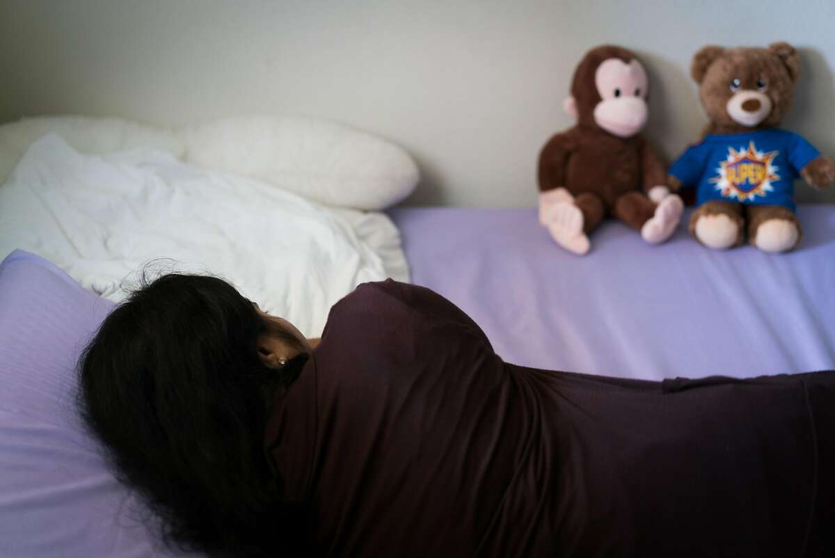A woman, who chooses to remain anonymous, rests on the bed inside of her home in Fremont, Calif. on Friday, June 29, 2018. The woman known as "Nisha," is waiting for the divorce from her husband to be finalized. Nisha's husband brought her to America on an H-4 visa in 2015. Although Nisha earned a masters degree in technology, she is unable to work due to her immigration status and hopes she can return to her family in India. Nisha expressed her concern for other women facing abuse who are not physically strong enough to survive. "Maybe this happened to me because I am strong. I can handle this, but I am worried about other women who can not," said Nisha.