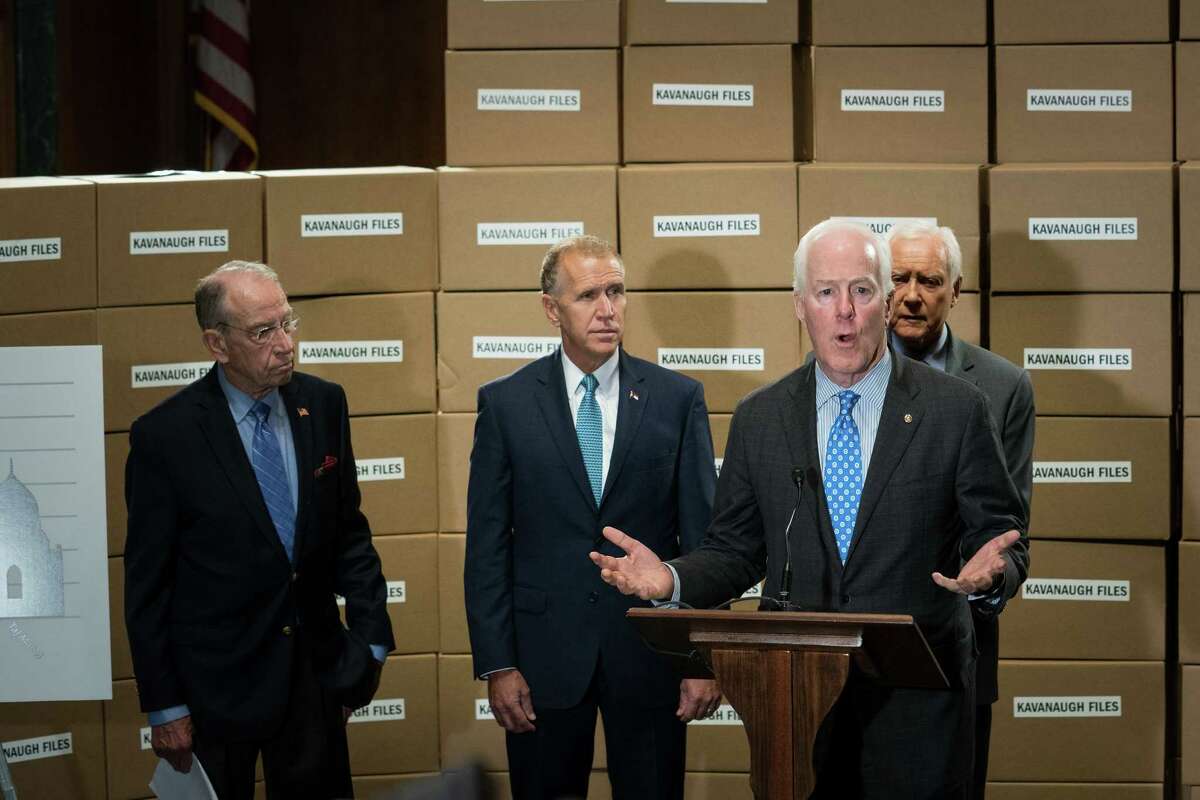 Sen. John Cornyn (R-Texas), joined by Sen. Chuck Grassley (R-Iowa), left; Sen. Thom Tillis (R-N.C.), second from left; and Sen. Orrin Hatch (R-Utah), speaks at a news conference about the nomination of Judge Brett Kavanaugh to the Supreme Court with Republican members of the Senate Judiciary Committee on Capitol Hill in Washington, Aug. 2, 2018. (Erin Schaff/The New York Times)