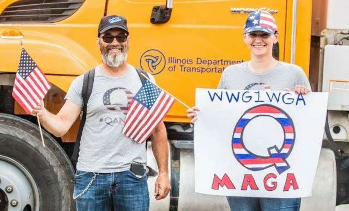 Members of the “QAnon” faction of President Donald Trump supporters show their pride last Thursday during the presidential visit to the U.S. Steel Granite City Works plant.