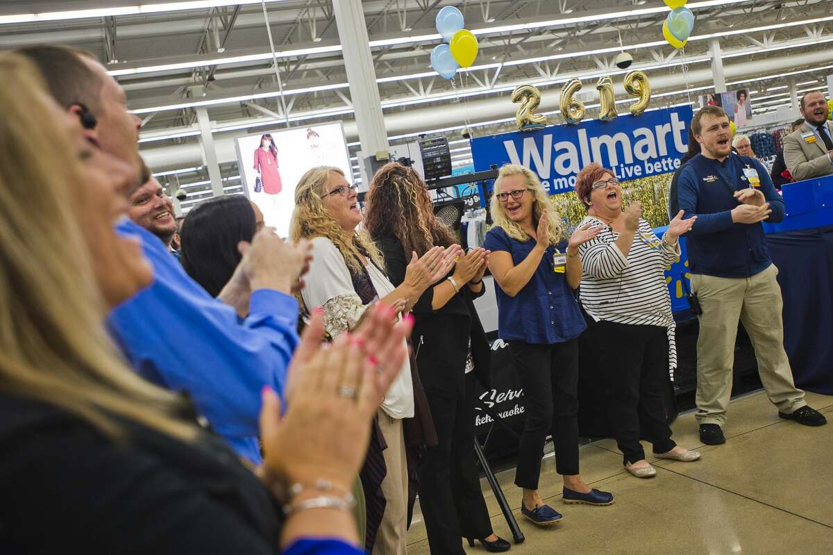 Staff of the Midland Walmart Supercenter at 910 Joe Mann Boulevard recite a cheer during an event celebrating recent storewide renovations on Friday, Aug. 3, 2018. (Katy Kildee/kkildee@mdn.net)