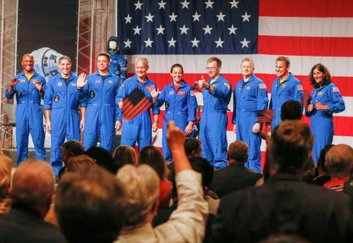Astronauts Victor Glover (left-right), Mike Hopkins, Bob Behnken, Doug Hurley, Nicole Mann, Chris Ferguson, Eric Boe, Josh Cassada, Suni Williams receive applause Friday, Aug. 3, 2018, in Houston. NASA Administrator Jim Bridenstine announced the crew assignments for the crew flight tests and the first post-certification mission for both Boeing and SpaceX.