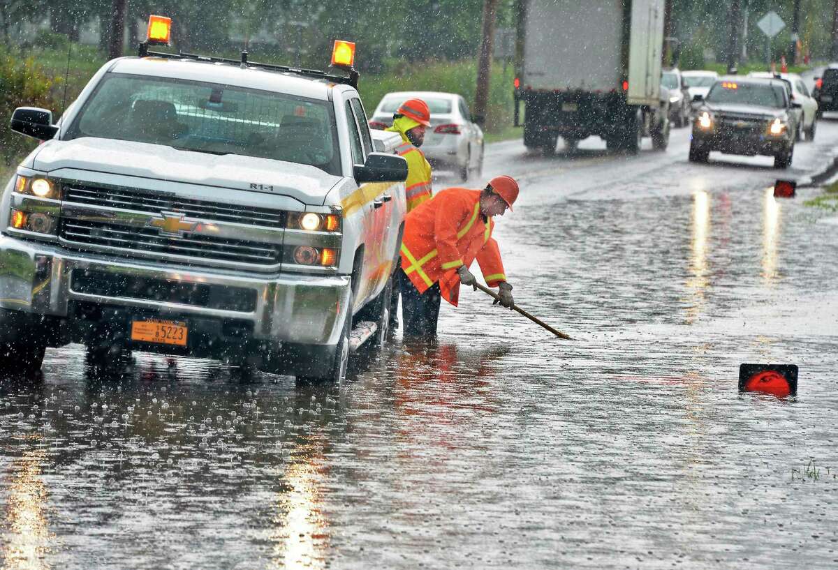 A DOT crew works on a flooded portion of Feura Bush Road Friday August 3, 2018 in Bethlehem, NY. (John Carl D'Annibale/Times Union)