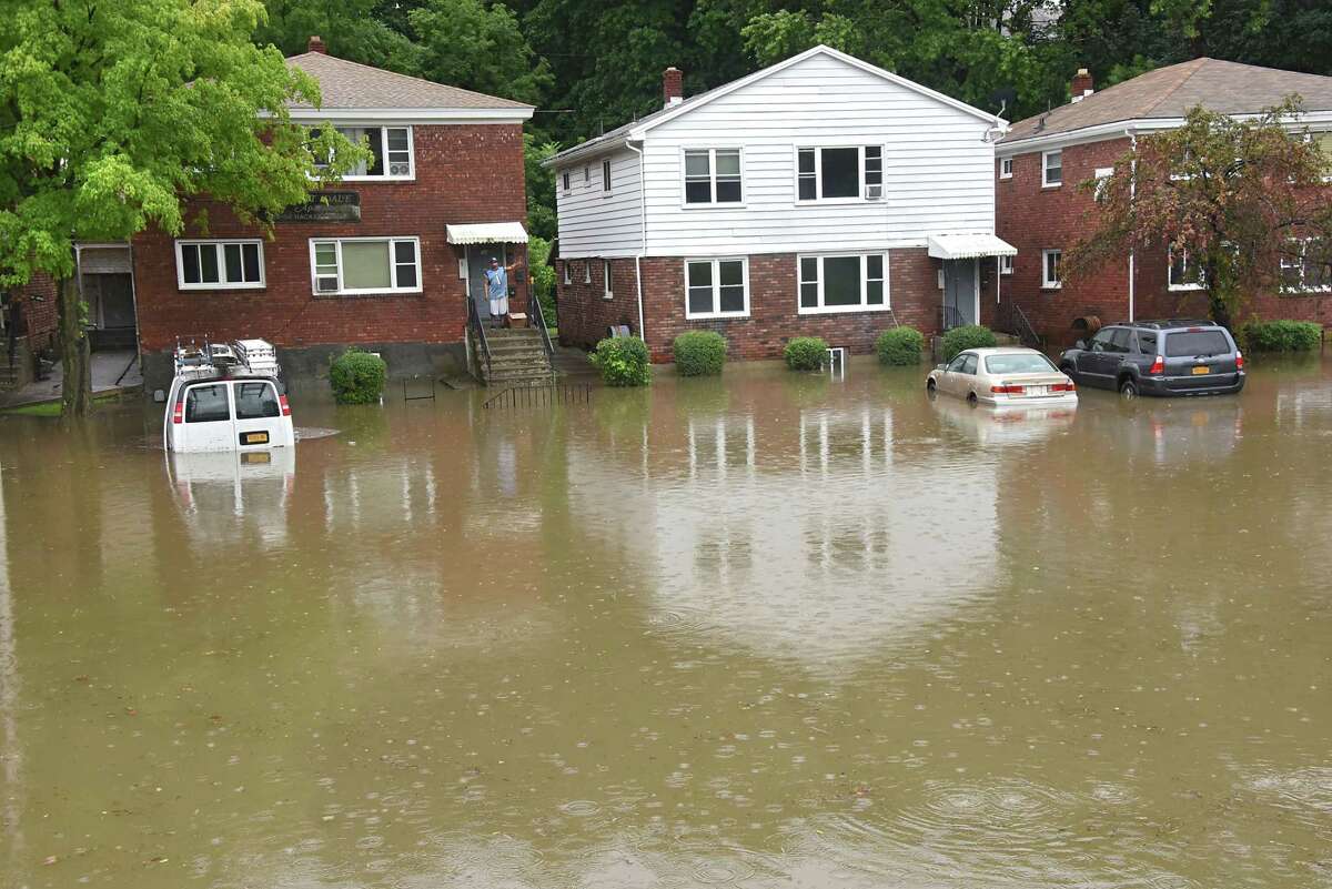 Flood water is seen half way up cars parked in driveways along Hackett Blvd. on Friday, Aug. 3, 2018 in Albany, N.Y. Heavy rains caused flash flooding in many areas of the Capital District. (Lori Van Buren/Times Union)