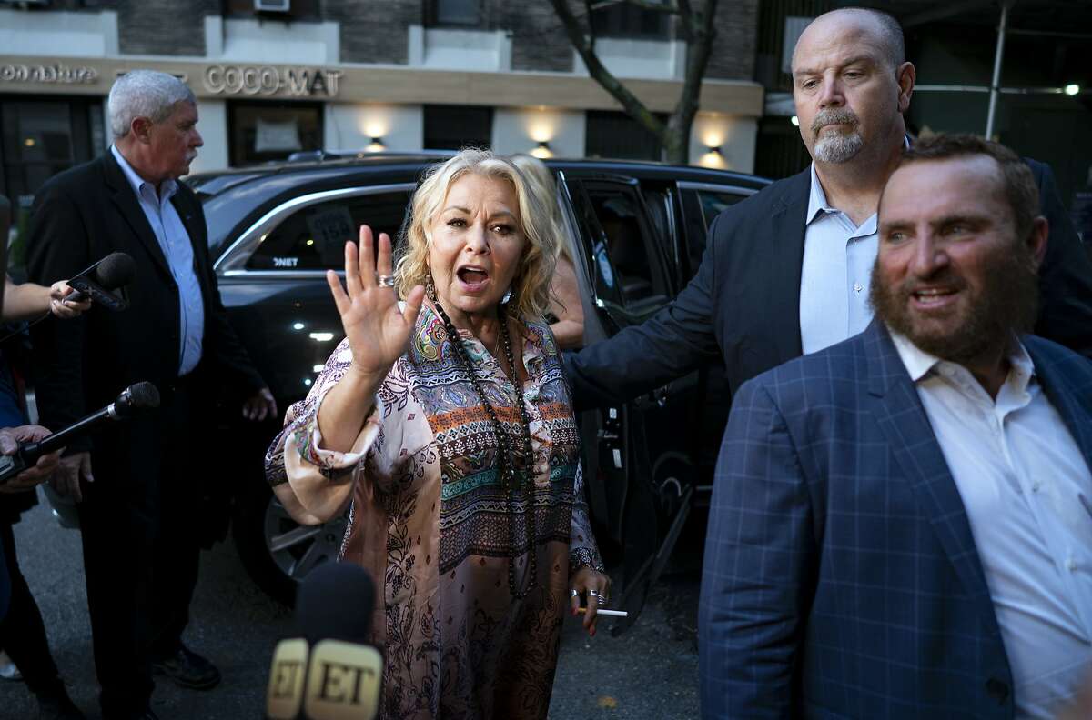 Comedian and actress Rosanne Barr, center, arrives to take part in a special event and podcast taping with Rabbi Shmuley Boteach, right, at Stand Up NY, Thursday, July 26, 2018, in New York. (AP Photo/Craig Ruttle)
