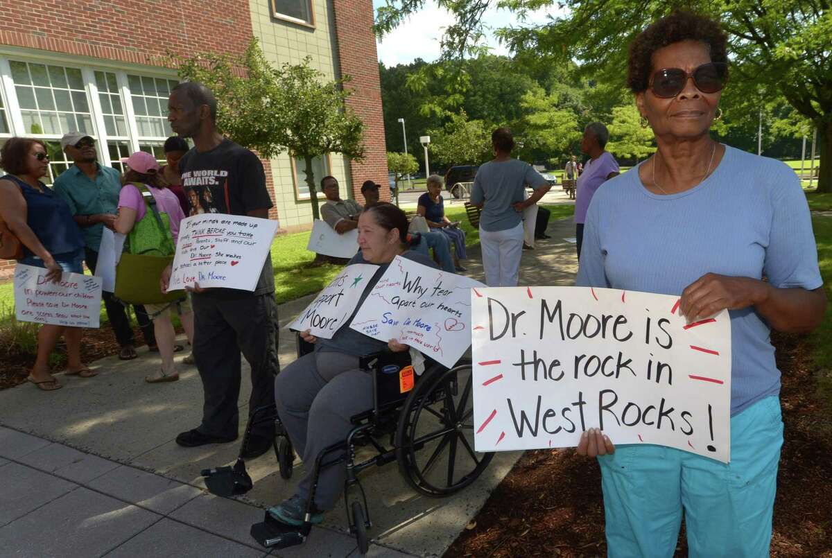 Parents and supporters of West Rocks Middle School principal Lynne Moore including Carolyn Walker protest outside City Hall Friday, August 3, 2018, as Moore attends a meeting with Board of Education officials about her imminent dismissal from the school in Norwalk, Conn.