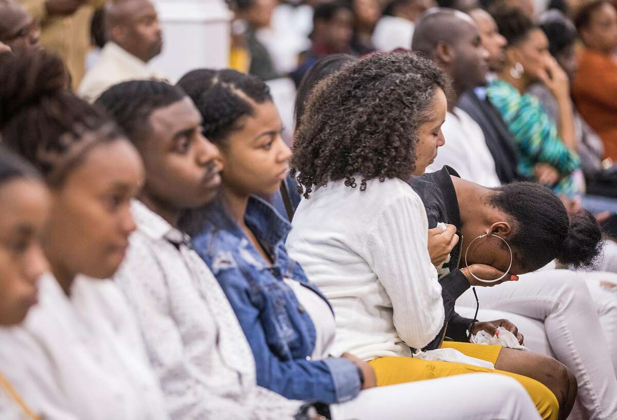A woman cries during a funeral service held for 18-year-old Nia Wilson of Oakland at Acts Full Gospel Church in Oakland, Calif. Friday, Aug. 3, 2018. Wilson was killed Sunday, July 22, 2018 at Macarthur Bart station in Oakland, Calif.