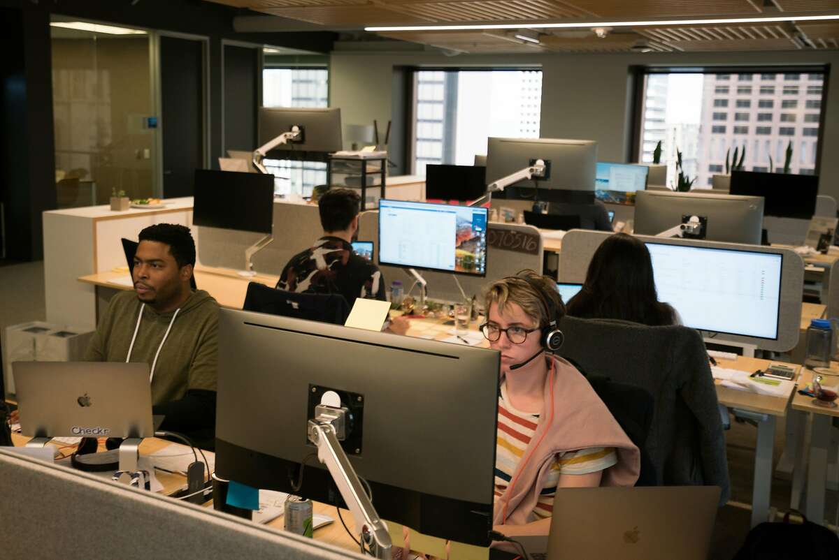 Employees work at Checkr, a background screening company in San Francisco Calif. on Monday, July 30, 2018. Checkr strategizes ways to hire people with more diverse backgrounds and create algorithms to eliminate bias. Checkr's mission is to provide "unique opportunity to help people with minor offenses get jobs," said communications director David Patterson. "We're about unlocking opportunity for everyone."