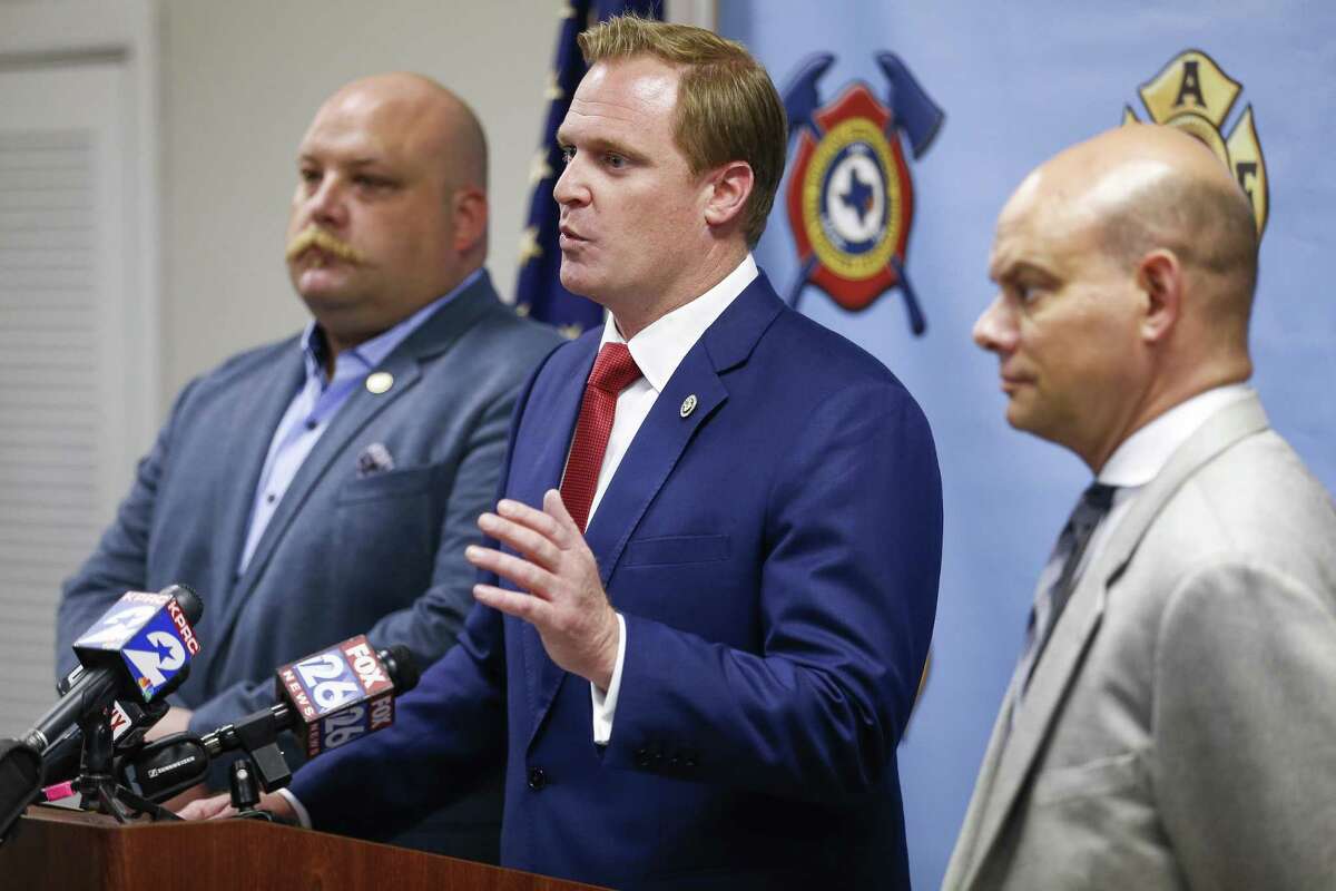 Houston Professional Fire Fighters Association president Patrick “Marty” Lancton, center, speaks to the media after a judge sided with the association that Houston’s City Hall improperly electioneered against firefighters pay measure Tuesday July 31, 2018 in Houston.