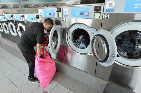 Laundry Love Brings Hope To Locals In Need The Hour - jeff chanholm loads a washing machine full of his clothes at giant laundry in east norwalk