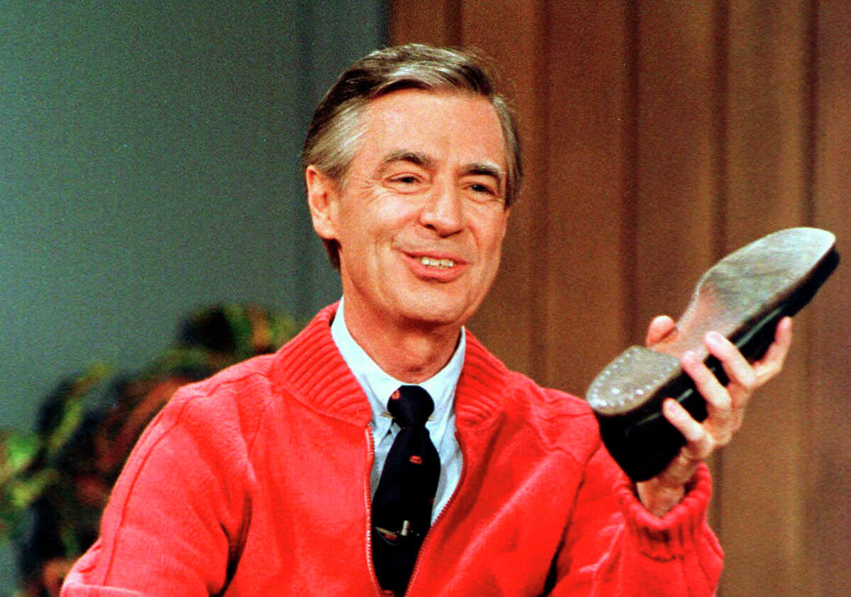 FILE - This June 28, 1989, file photo, shows Fred Rogers as he rehearses the opening of his PBS show "Mister Rogers' Neighborhood" during a taping in Pittsburgh. Rogers' legacy back in the spotlight, PBS wants viewers to remember that public television was the longtime home of ?“Mister Rogers?’ Neighborhood.?” PBS stations will air the acclaimed documentary "Won't You Be My Neighbor?" as part of the "Independent Lens" showcase. (AP Photo/Gene J. Puskar, File)