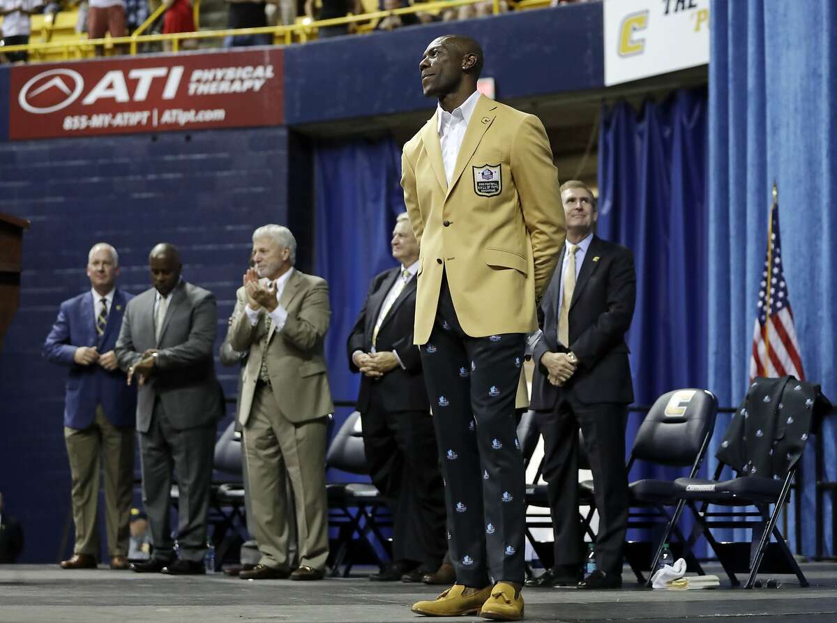 Former wide receiver Terrell Owens is applauded after he was given his Pro Football Hall of Fame coat on Saturday, Aug. 4, 2018, in Chattanooga, Tenn. Instead of speaking at the Hall of Fame festivities in Canton, Ohio, Owens celebrated his induction at the University of Tennessee at Chattanooga, where he played football and basketball and ran track. (AP Photo/Mark Humphrey)