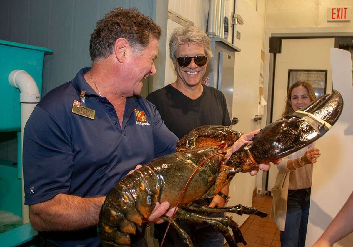 Stew Leonard Jr., left, presents Jon Bon Jovi with a 20-pound lobster. Rocker Jon Bon Jovi made a surprise visit to a Stew Leonard's supermarket recently to support a family business venture and to collect some special groceries.